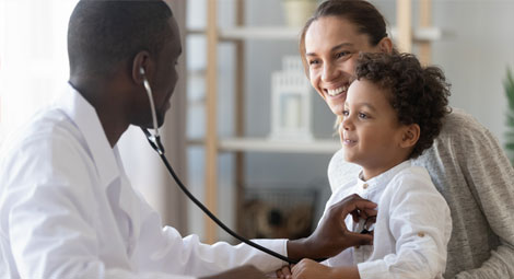 Doctor using a stethoscope on a child